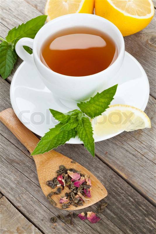 Green tea with lemon and mint on wooden table background, stock photo