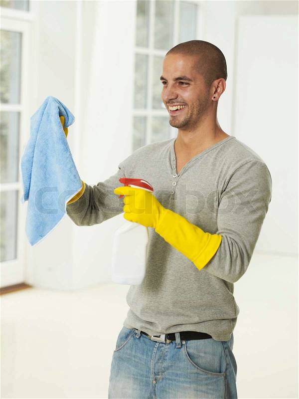 Portrait of a man with a cleaning product, stock photo