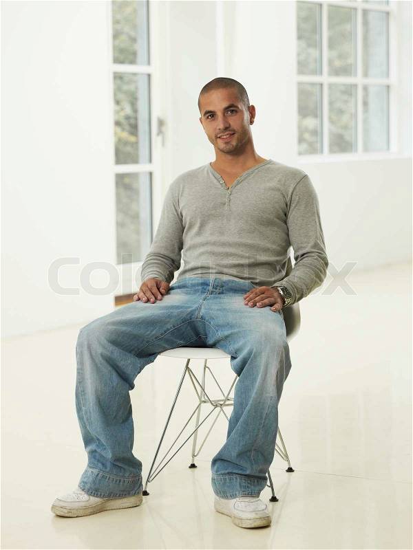Portrait of a man sitting on a chair, stock photo