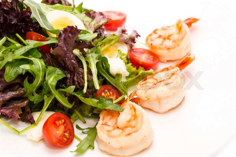 Salad greens and shrimp on a white background in the restaurant, stock photo