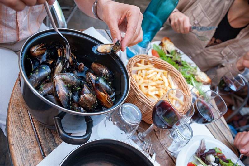Steamed mussels with fries and wine, stock photo