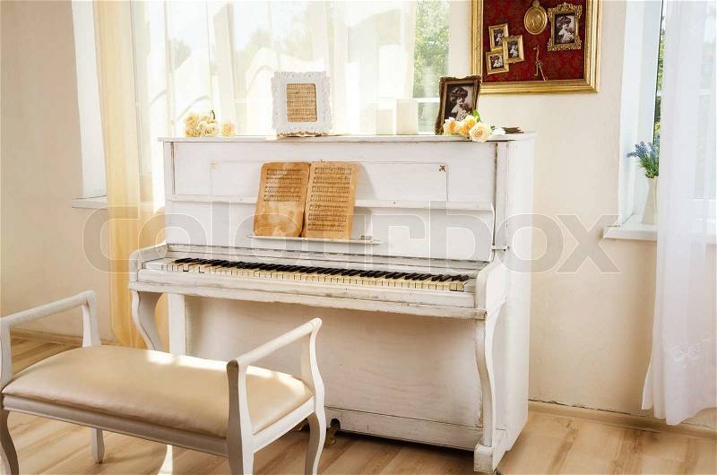 Old white piano in vintage interior, stock photo