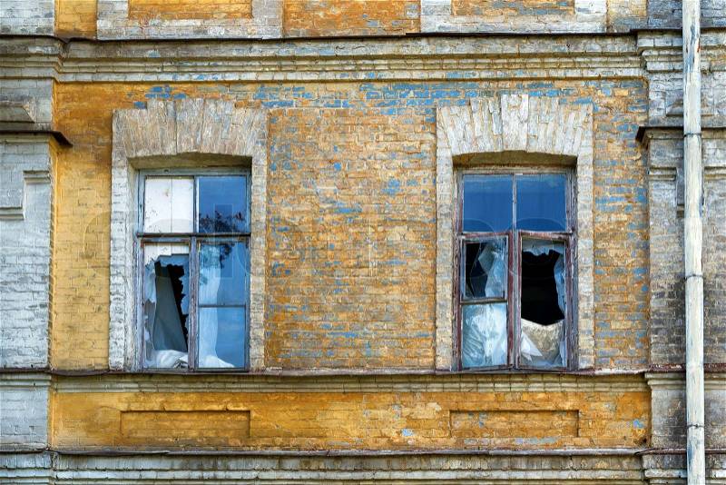 Broken windows of an abandoned house, stock photo