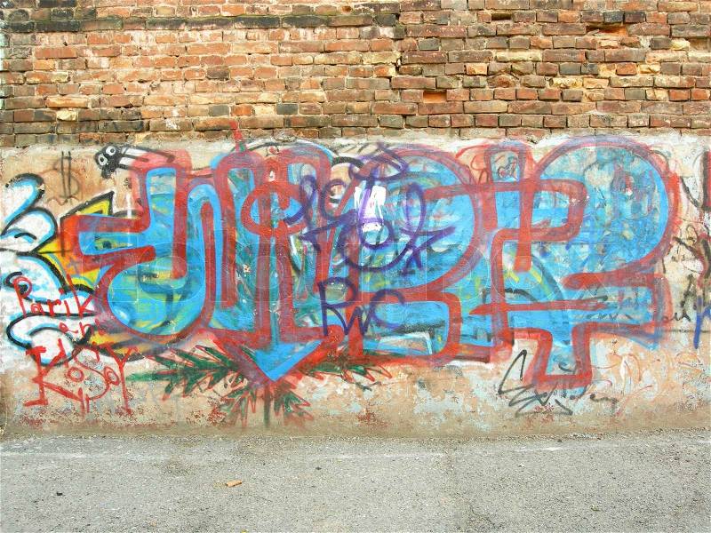 Graffiti on a brick wall of an old house, stock photo