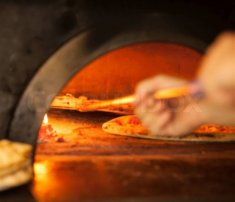 Pizza baking close up in the oven, stock photo