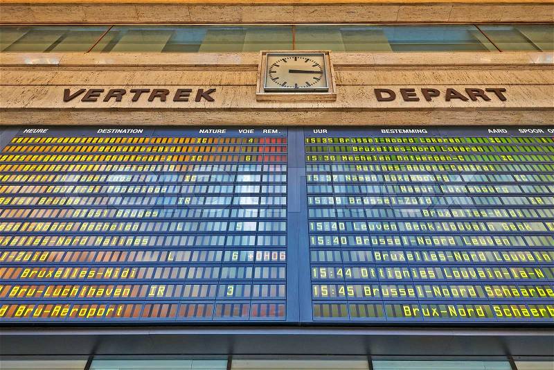 A schedule board in a train station with information telling the time and destinations for travelers, stock photo
