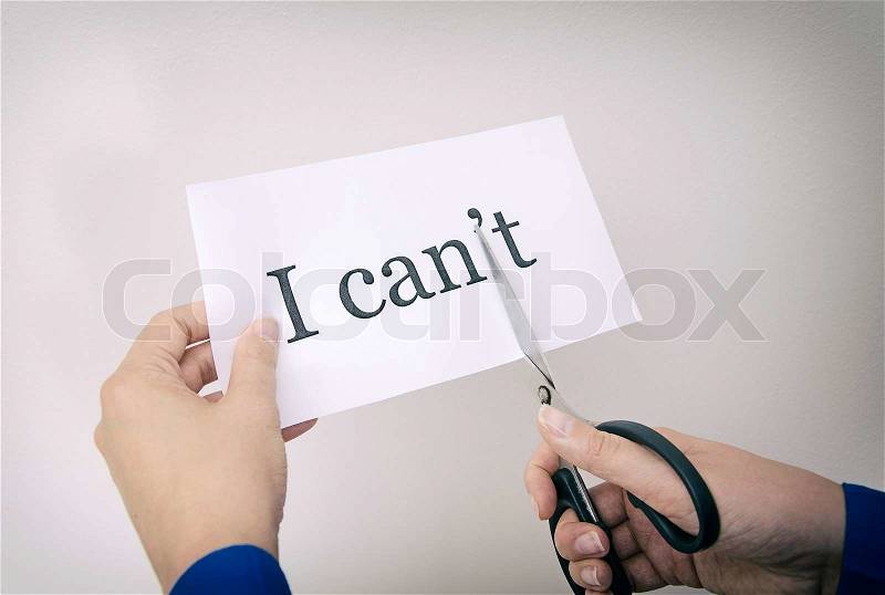 Female hand cutting paper with words. Concept, stock photo