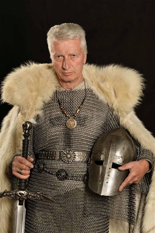 Mature Medieval knight on a dark background, stock photo