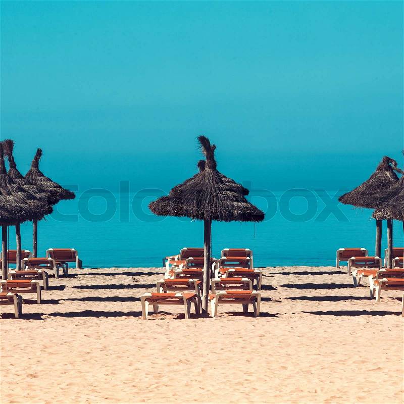 Beach scenery with parasol and deck chairs. umbrella and deck chairs, stock photo