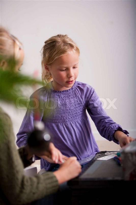 Two young caucasian girls playing cards, stock photo