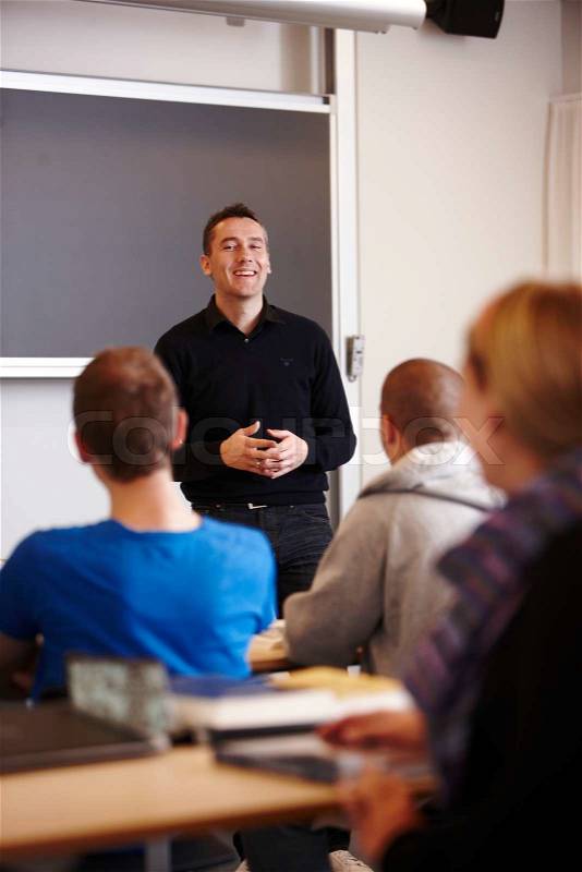 A school professor lecturing his students in a university auditorium, stock photo