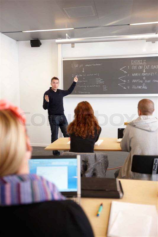 A school professor lecturing his students in a university auditorium, stock photo