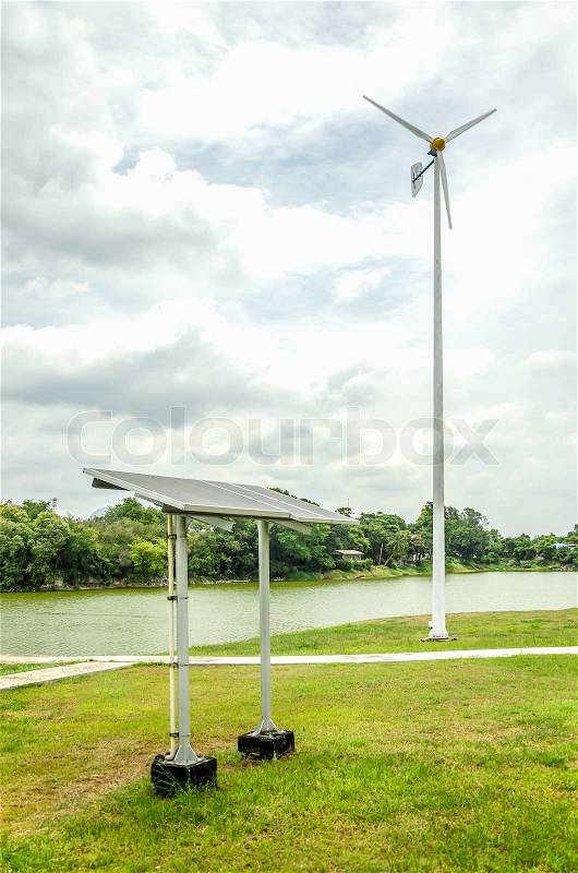 Solar panels with wind turbine for renewable electric energy production, stock photo