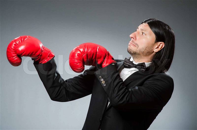 Man businessman with boxing gloves, stock photo