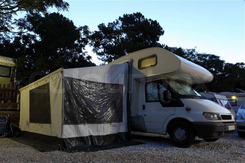 Mobile home on a camping site at dusk, stock photo