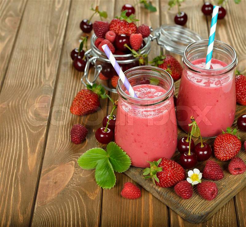 Berry smoothie on brown background, stock photo
