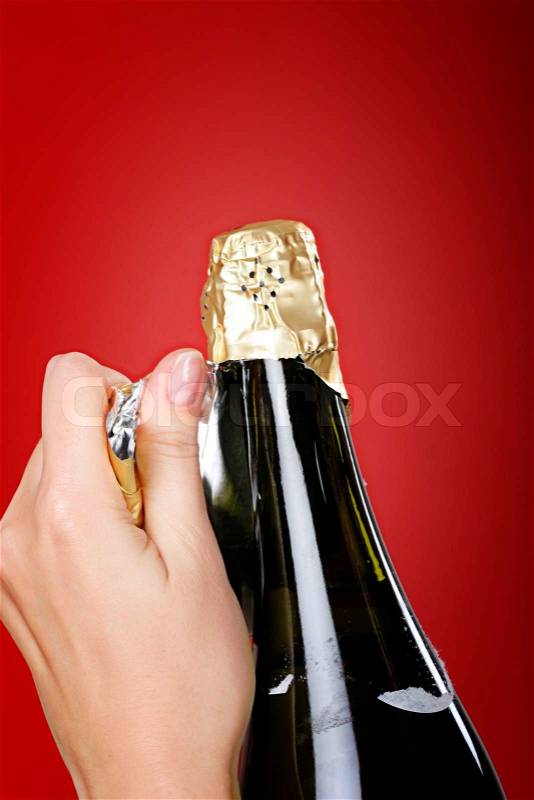 Woman hands opening champagne bottle, stock photo