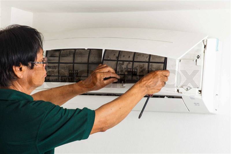 Man repair air conditioner , stock photo