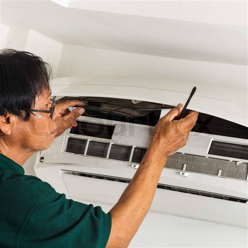 Man repair air conditioner , stock photo