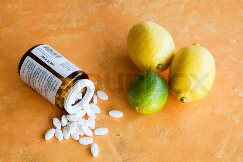Vitamin supplements and citrus fruits, stock photo