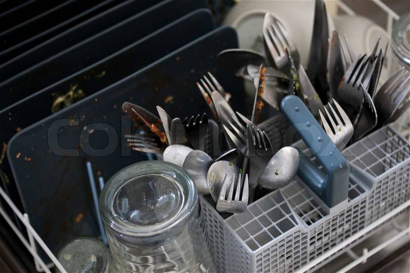 Dishwasher with dirty kitchen wares, stock photo