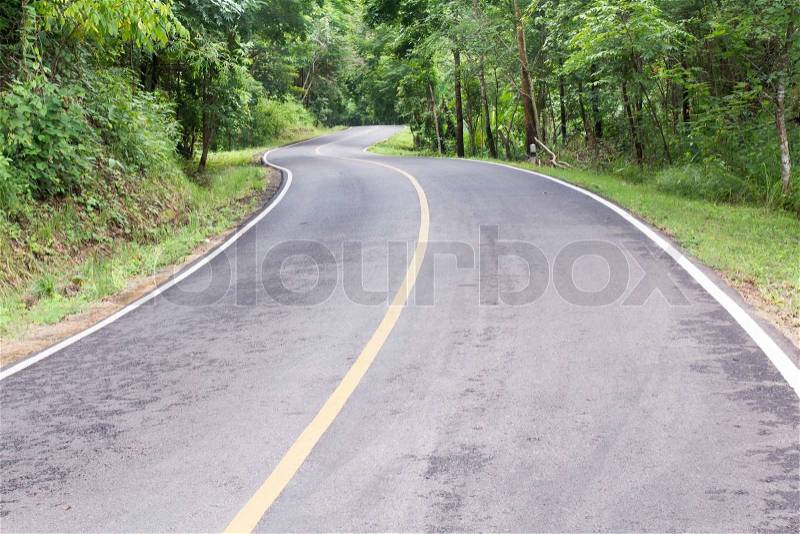 Curve way of asphalt road through the tropical forest in northern Thailand, stock photo