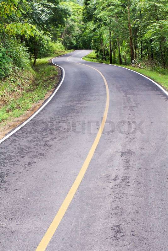 Curve way of asphalt road through the tropical forest in northern Thailand, stock photo
