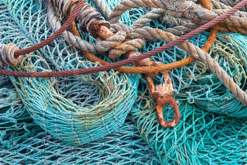 Abstract background with a pile of fishing nets ready to be cast overboard for a new days fishing, stock photo