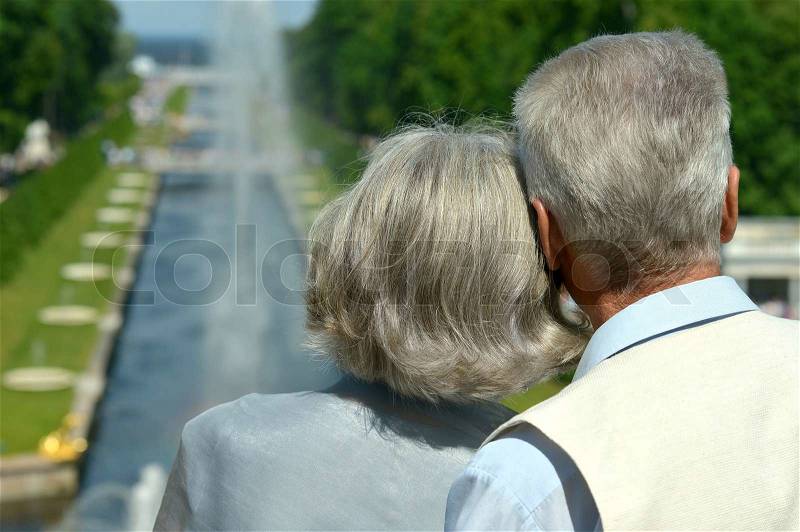 Back view of retired happy couple outdoors, stock photo