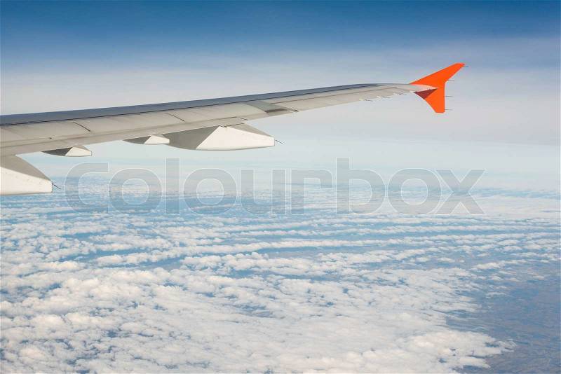 Airplane wing out of window, stock photo