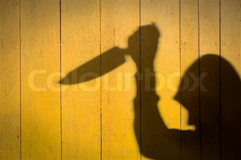 Male Hand Shadow with Kitchen Knife, on wood wall, stock photo