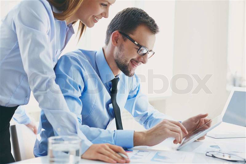 Image of two successful business partners working at meeting in office, stock photo