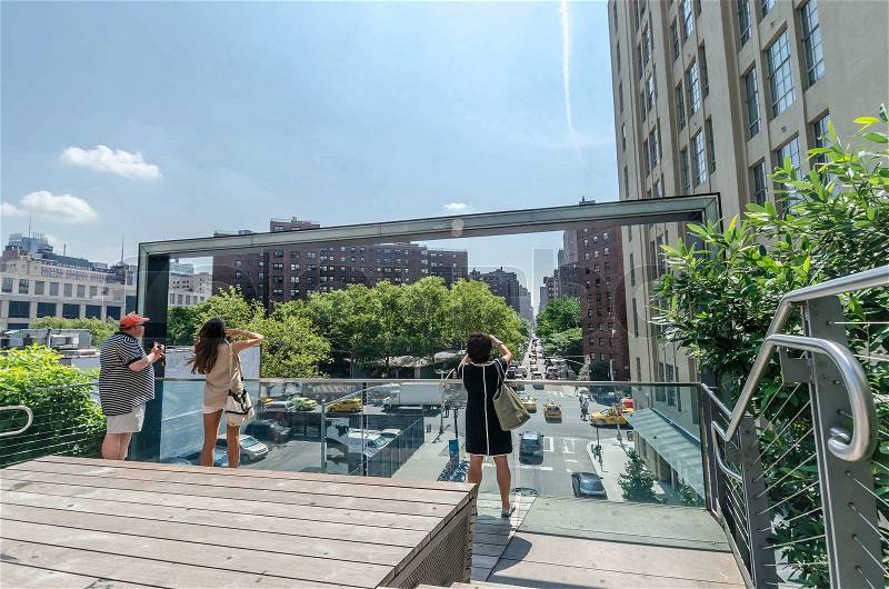 NEW YORK CITY - JULY 22: People walk along the High Line Park on July 22, 2014. The High Line is a popular linear park built on the elevated former New York Central Railroad spur in Manhattan, stock photo