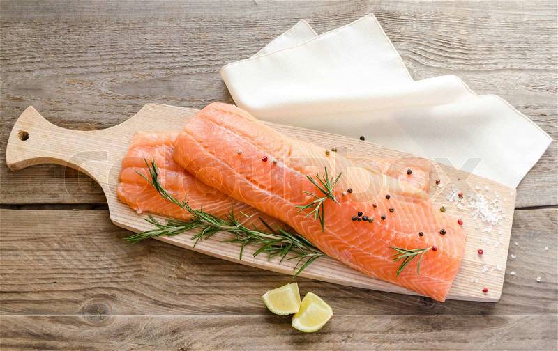 Raw salmon steaks on the wooden board, stock photo
