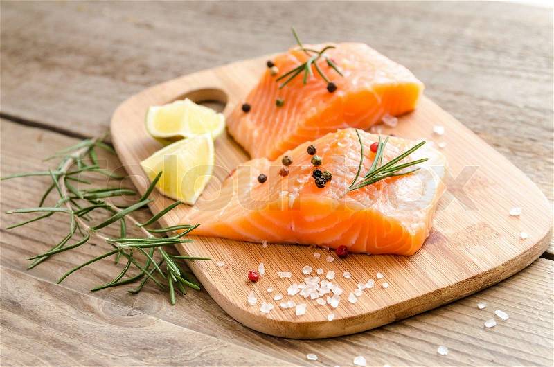 Raw salmon steaks on the wooden board, stock photo