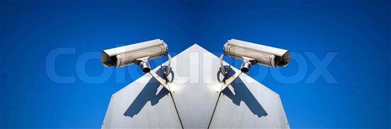 Big Brother cameras on building and sky blue, stock photo