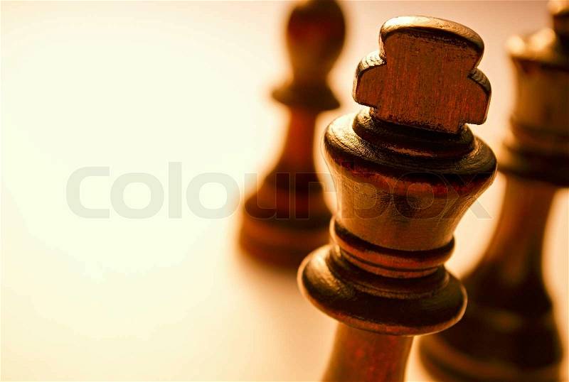 Macro Wooden King Chess Piece on White Background. King Piece is the Highest Royalty in Chess Board Game, stock photo