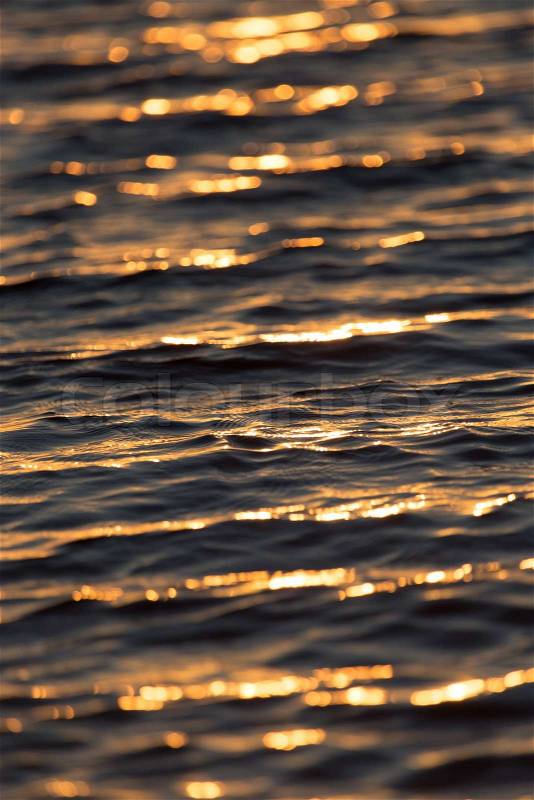 Seamless texture warm color shining sunset water surface, stock photo