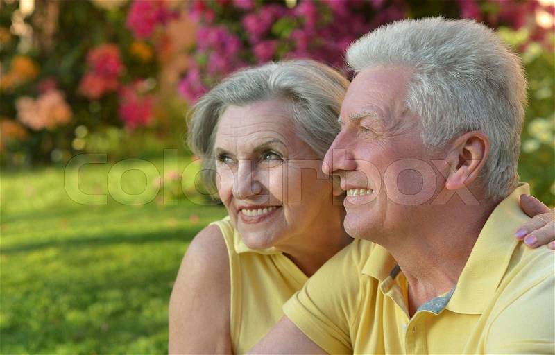 Portrait of beautiful retired couple outdoor in summer park, stock photo