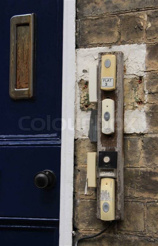 Students house with blue door, rust mailbox and many doorbells on the left side, stock photo
