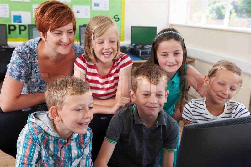 Group Of Elementary Pupils In Computer Class With Teacher, stock photo