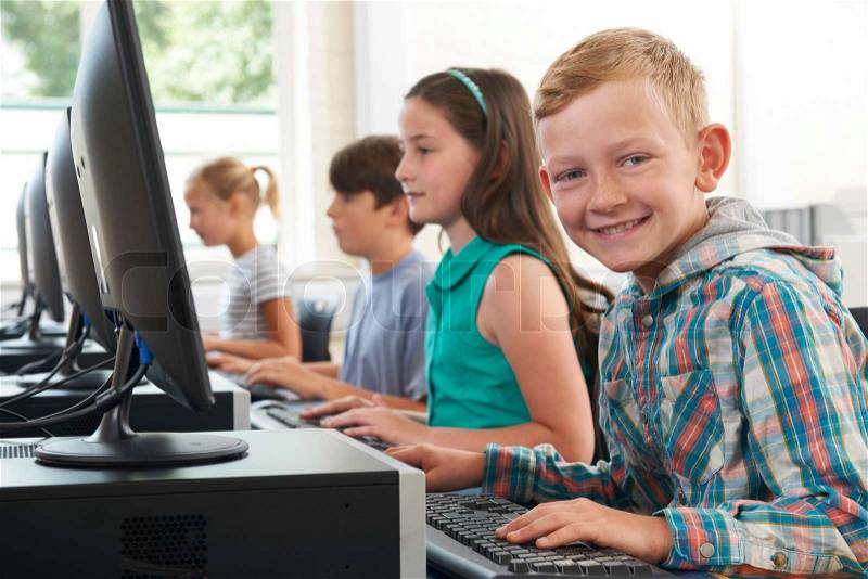 Group Of Elementary School Children In Computer Class, stock photo