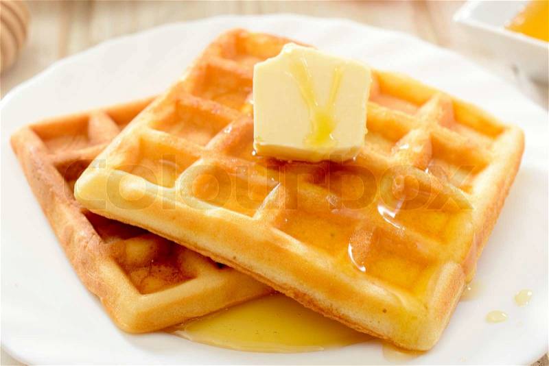Traditional Belgian waffles with honey and butter, stock photo