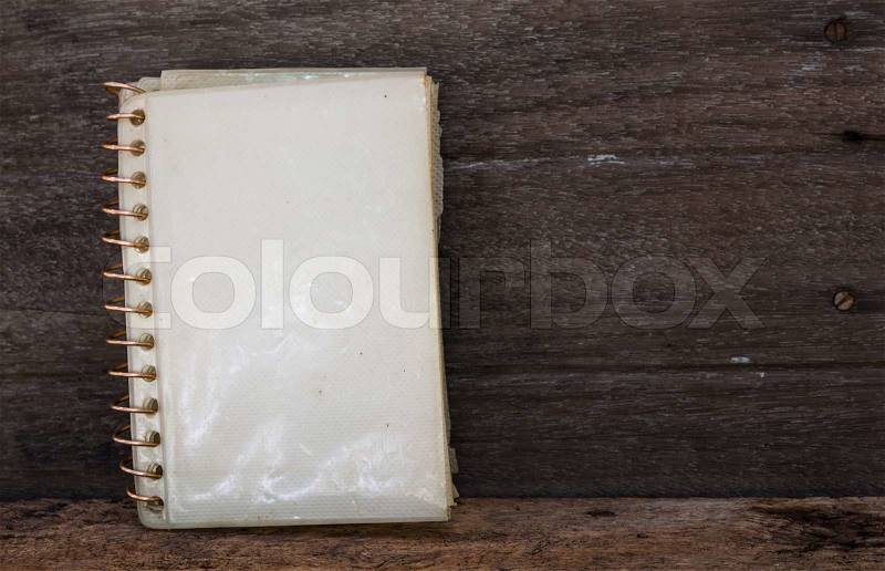 Open diary or photo album on old wooden table, stock photo