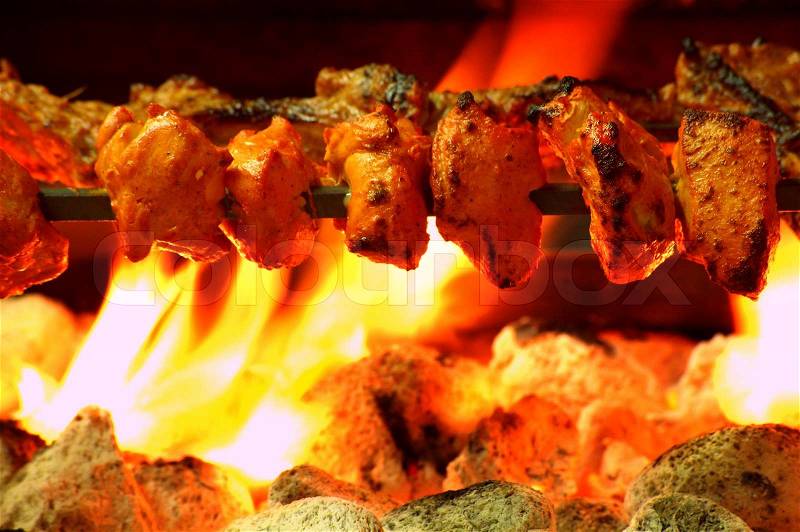 Chicken tikka kebab over coal bbq, stock photo