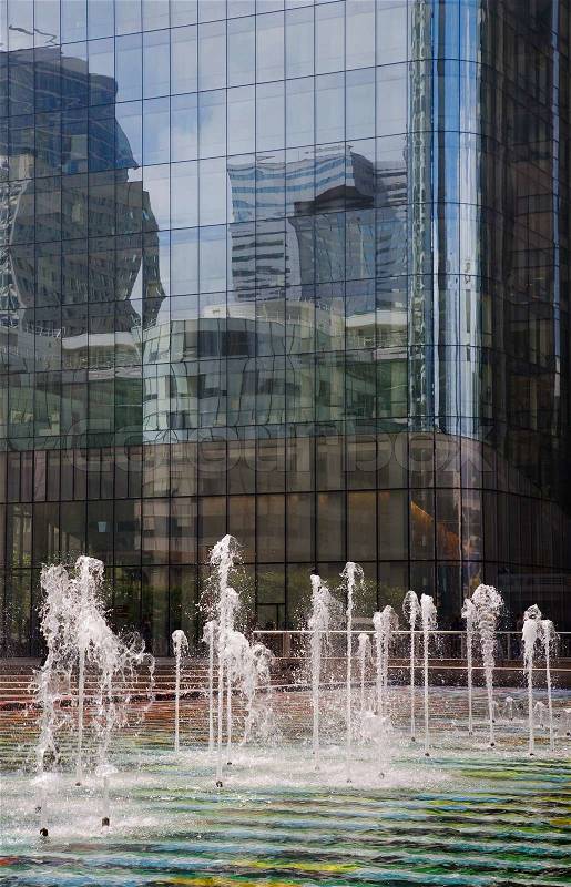 Fountain in front of futuristic corporate office buildings - La Defense, Paris, stock photo