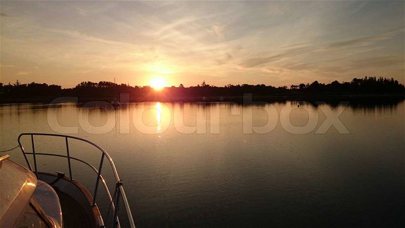 Sunset seen from the side of a boat, stock photo