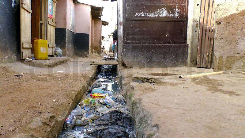 A street in Ghana were trash is lying in the gutter, stock photo