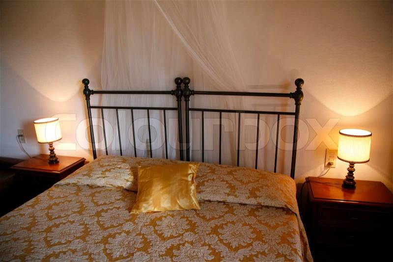 Iron bed - Italian hotel room. Natural lightening, stock photo