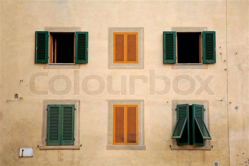 Green for real and yellow for fake windows seen in a little Italian town, stock photo